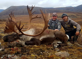 Two Hunters with a Caribou