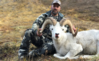 Hunter and Sheep On Grass