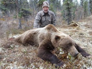 Hunter with Grizzly Bear in the Forest